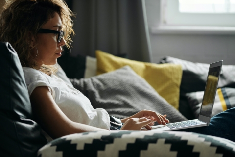 Person working on their laptop on their couch