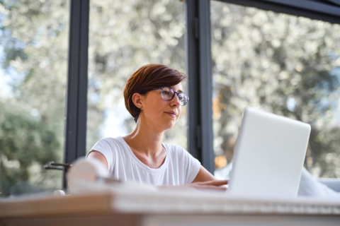 Woman typing on a laptop